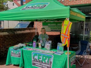 Karen Demyanovich helps at AAACERT tent